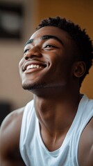 Poster - BIPOC man smiling while setting up his home gym in his new space Stock Photo with side copy space