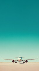 Poster - White passenger airplane is standing on an airport runway, under a clear blue sky, waiting to take off for a new journey
