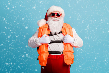 Portrait of his he attractive cheerful cheery confident white-haired Santa father seaman swimmer instructor wearing safe vest rest ocean isolated bright vivid shine vibrant blue color background