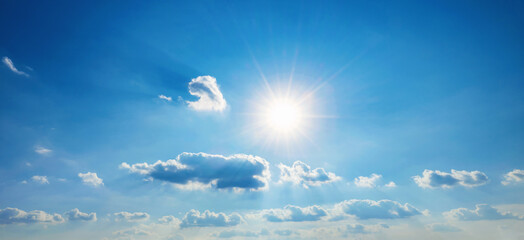Wall Mural - sky is blue with a few clouds and the sun is shining brightly