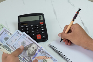 A man is counting Dollar banknotes, financial management concept