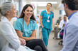 © Alberto Gonzalez  - Joyful healthcare professionals conversing, with a focus on a smiling woman in a white lab coat with a stethoscope.