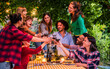 © Davide Angelini - Happy friends toasting red wine glasses at farm house vineyard countryside - Young people having fun together outdoors