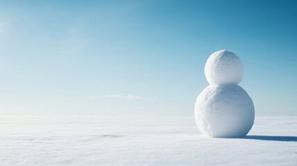 Wall Mural - simple snowman standing in a wide snowy field under a clear blue sky, representing winter, holidays,