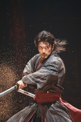 Dynamic Samurai Warrior in Traditional Japanese Robe with Swirling Particles Background - Intense Warrior Holding Sword in Dramatic Close-Up, Cinematic Action Scene for Gaming or Movie Poster