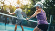 © Antto-AI - Older woman playing pickleball with partner, enjoying game outdoors