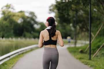 Runner's Serenity: A woman jogging in a park, enjoying a peaceful run.  The image evokes a sense of calm and well-being.