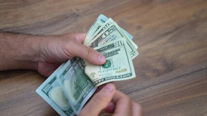 Poster - Male worker carefully counts dollar banknotes from various jobs evaluating earnings and budgeting for rent and essentials showing hustle required to make ends meet