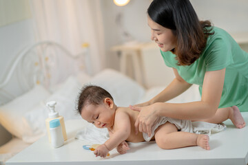 Asian baby and woman doing lifestyle activities together at home.