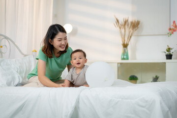 Asian baby and woman doing lifestyle activities together at home.