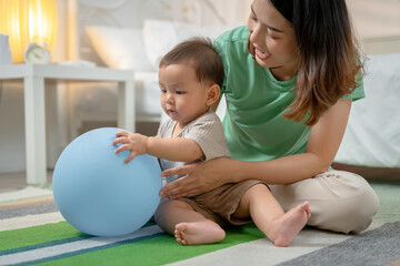 Asian baby and woman doing lifestyle activities together at home.