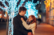 © Zamrznuti tonovi - Happy festive couple hugging on street and celebrating new year's eve.