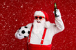 © deagreez - Close-up portrait of his he attractive cheerful fat white-haired Santa drinking beer having fun holding soccer ball isolated bright vivid shine vibrant red burgundy maroon color background