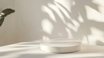 Minimalist white object on table with soft shadows creating a calm atmosphere in a contemporary setting