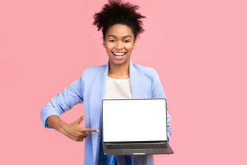 Poster - Useful Website. Young black woman pointing at laptop computer blank screen over pink studio wall. Mock up, copyspace