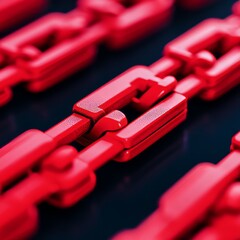 Close-up of interconnected red chain links on a dark background.