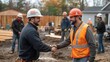 © Vilaphon  - A contractor and client engaged in a handshake at a renovation site, with construction workers in the background actively working, highlighting teamwork and project development