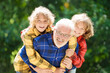 © famveldman - Grandfather and kids in sunny garden