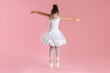 © New Africa - Little ballerina practicing dance moves on pink background