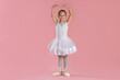 © New Africa - Little ballerina practicing dance moves on pink background