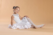 © New Africa - Portrait of little ballerina on beige background