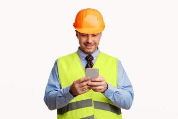 Poster - Construction Worker Using Smartphone Application Standing On White Studio Background. Mobile App Concept