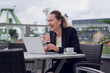 © Scopio - Business women working outdoors with a laptop