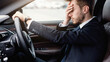 © Prostock-studio - Fatigue Concept. Exhausted manager in despair driving car, having headache, feeling stressed