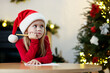 © New Africa - Little girl writing letter to Santa Claus at table indoors. Christmas celebration
