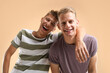 © New Africa - Portrait of happy brothers on beige background