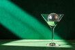 © cato_rium - Mini disco ball in martini glass on emerald green background. Cocktail party, disco concept. Modern template for New Year cards, Christmas holidays, birthday and club events with place for text