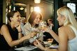 © Marko Geber - Businesswomen celebrating success with drinks after work