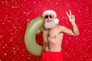 Portrait of his he nice attractive funky confident positive cheerful cheery gray-haired man carrying pond circle summertime leisure showing v-sign isolated over bright vivid shine red background