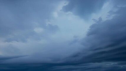 Poster - Ominous dark clouds gather in the sky, forming surreal shapes and creating a mysterious atmosphere. The scene evokes a dramatic and moody feeling, perfect for capturing nature's intensity