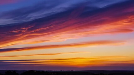 Poster - Mesmerizing sunset paints the sky with vibrant hues of orange, purple, and blue, creating a surreal and captivating atmospheric display