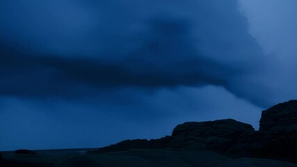 Wall Mural - dark and dramatic sky looms over a rugged coastline, with storm clouds gathering and casting an eeri