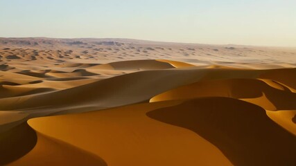 Aufkleber - Surreal desert scenery showcases the sun shifting across the sky, casting dynamic shadows over the undulating sand dunes, highlighting the vastness and beauty of the arid landscape