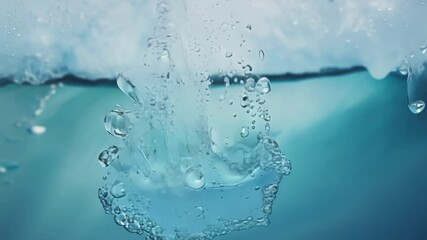 Aufkleber - Water droplet descends underwater, creating a large surreal bubble filled with smaller bubbles. The surrounding water showcases a vibrant turquoise hue, enhancing the visual appeal