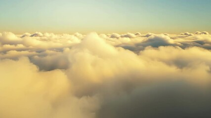 Poster - Surreal cloudscape with golden light bathing fluffy clouds. The horizon stretches far, creating a sense of peace and wonder