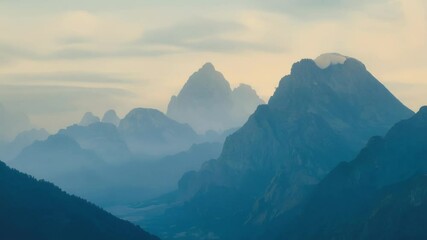 Aufkleber - Mountain range is slowly changing as fog passes through the peaks. The surreal landscape appears to be moving and transforming