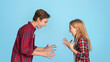 © Prostock-studio - Siblings Conflicts. Angry Little Brother And Sister Emotionally Screaming At Each Other, Standing On Blue Background With Free Space