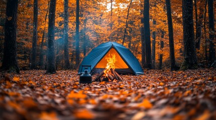 Fototapete - A blue tent is pitched amidst a vibrant forest filled with orange and yellow leaves. A warm campfire crackles nearby, enhancing the cozy atmosphere of the evening.