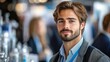 © Muamanah - A Young Man with Brown Hair and a Beard Looks Directly at the Camera