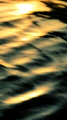 Poster - Abstract reflection of golden sunlight on water surface, serene nature background. Tranquility and calmness concept