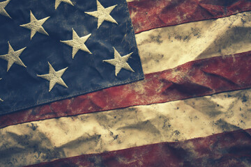 American flag with stars waving boldly against a clear blue sky.