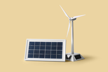 Wind turbine model and solar panel on beige background