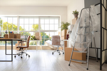 Wall Mural - Desks with chairs and boxes in office on moving day