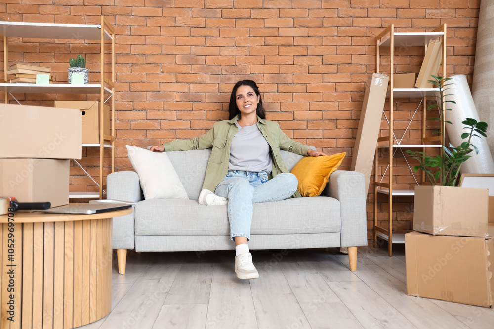 Beautiful woman sitting in room on moving day