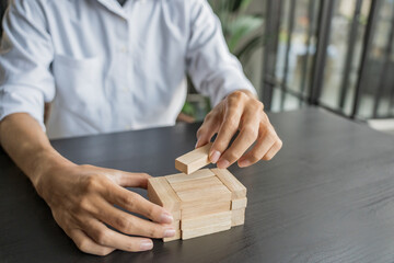 Planning risk and strategy in businessman gambling placing wooden block.Business concept for growth success process.