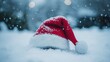 © Jaruwan - Red Santa Hat on Snowy Ground in Winter Scene